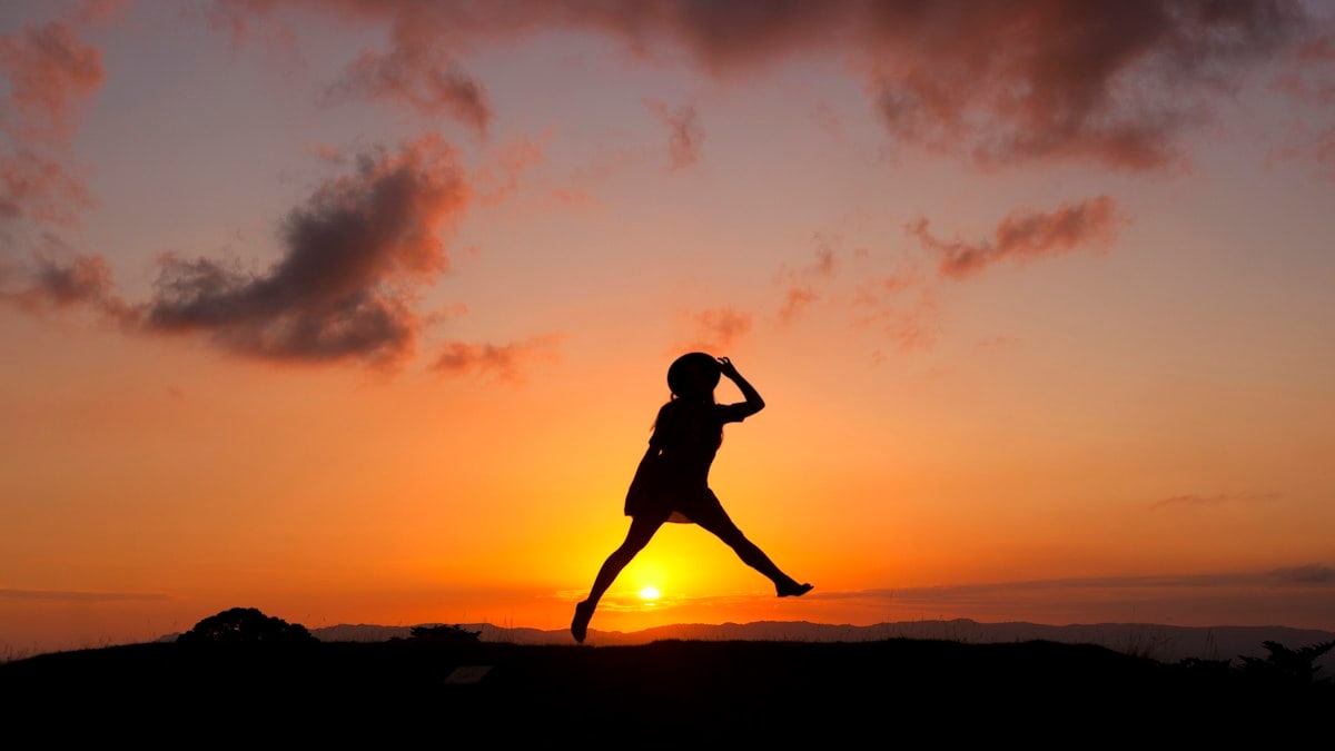 silhouette of human jumping during sunset
